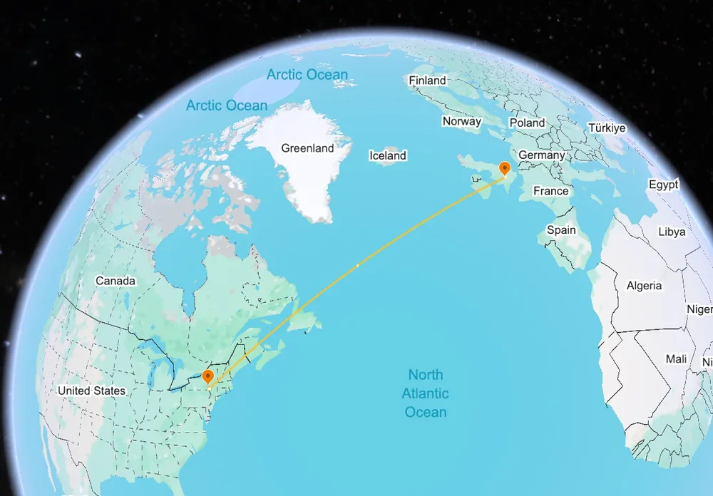A 3D globe seen from above the North Atlantic: the route from New York to Europe runs up past Greenland and Iceland.